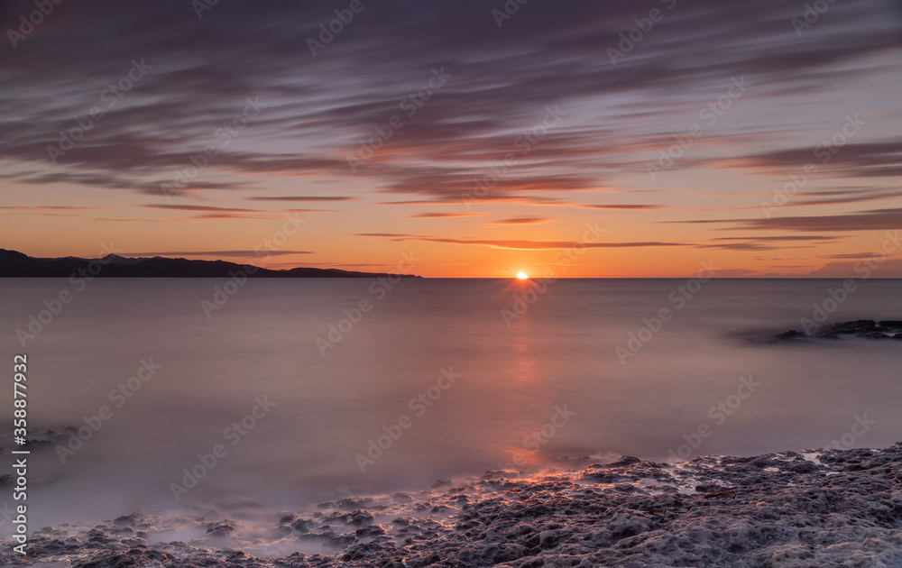 Orange sunset over the Mediterranean Sea from the island of Corsica