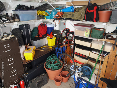 Big messy pile of stored items in typical suburban garage.