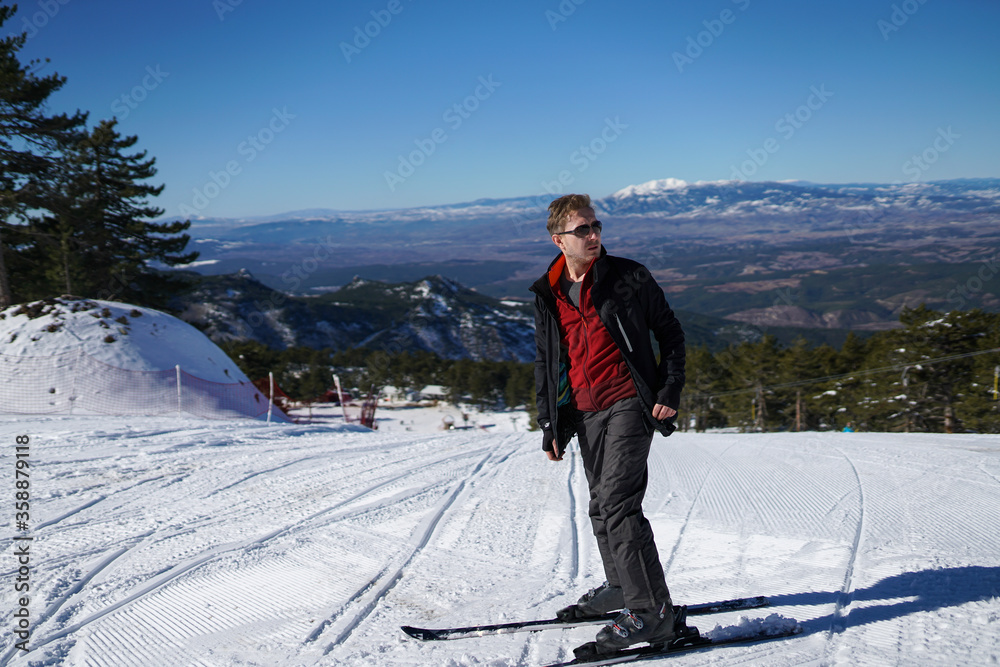 Male model posing on ski slope