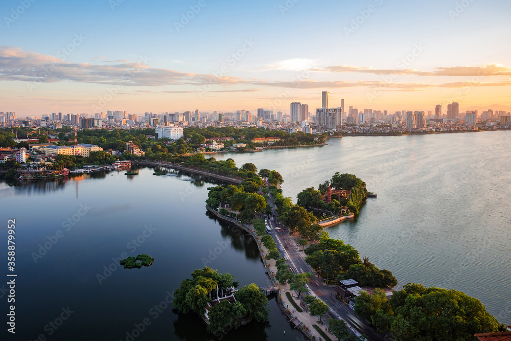 Aerial view of Hanoi skyline showing West Lake and Tay Ho District at sunset in Hanoi, Vietnam.