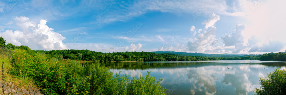 colorful panorama of autumn lake on a bright sunny day