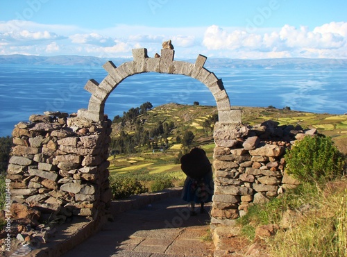 Stone arch with view on lake Titicaca on Amantani Island (Peru) photo
