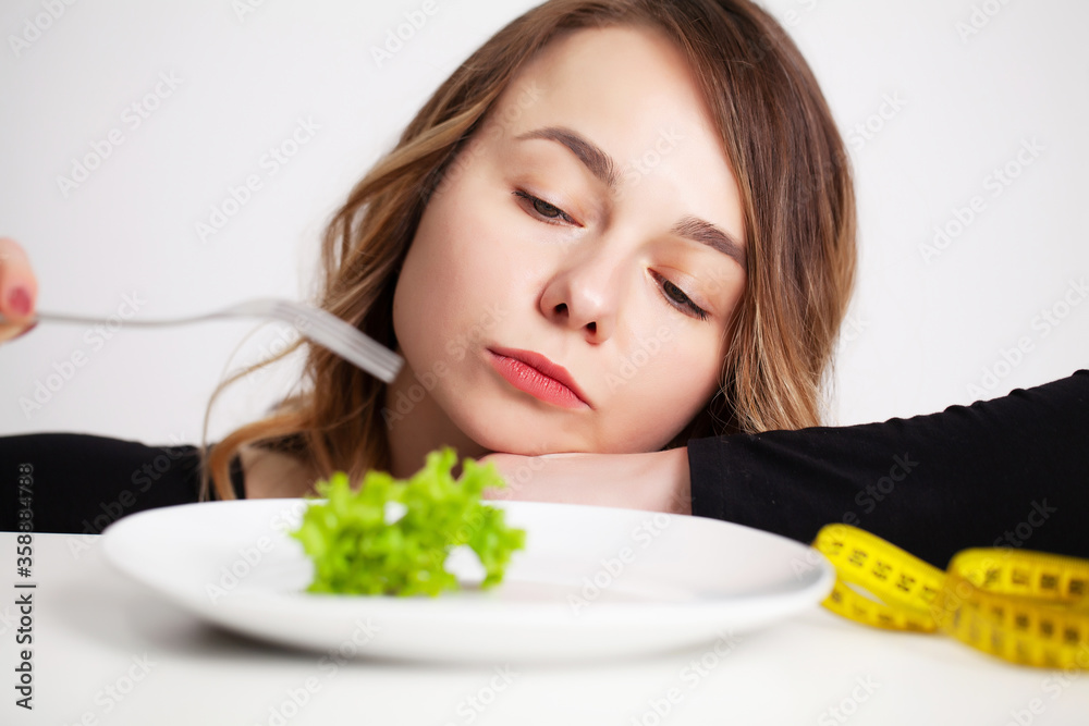 Young woman holding green broccoli, healthy way to lose weight Young woman holding green broccoli, healthy way to lose weight