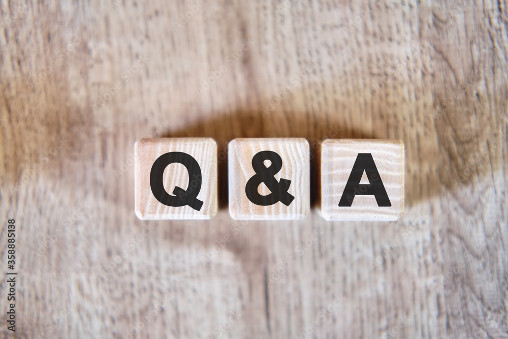 Fototapeta premium Questions and answer - text on wooden cubes, on wooden background