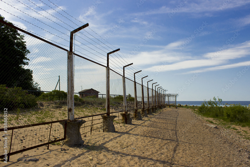 high mesh fence and barbed wire around the protected area high mesh fence and barbed wire around the protected area