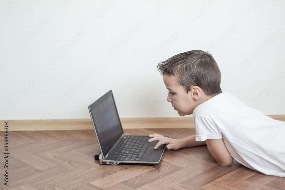 boy uses a laptop boy uses a laptop