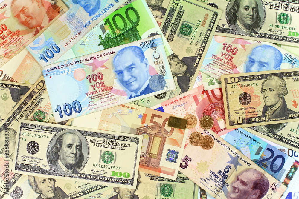 Background from dollars and euro bills. One hundred Turkish Lira banknote on other currencies Background from dollars and euro bills. One hundred Turkish Lira banknote on other currencies
