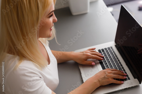 Close-up Of Young Woman Using Laptop online at home