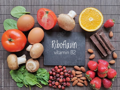 Foods rich in vitamin B2 (riboflavin). Healthy natural sources of vitamin B2: mushroom, spinach, onion, almond, dark chocolate, rose hips, strawberry, orange, egg, tomato. photo