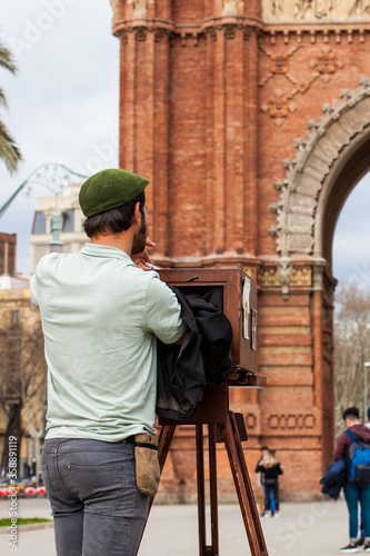 Photography Young male photographer taking pictures using a vintage wooden camera at the Tri