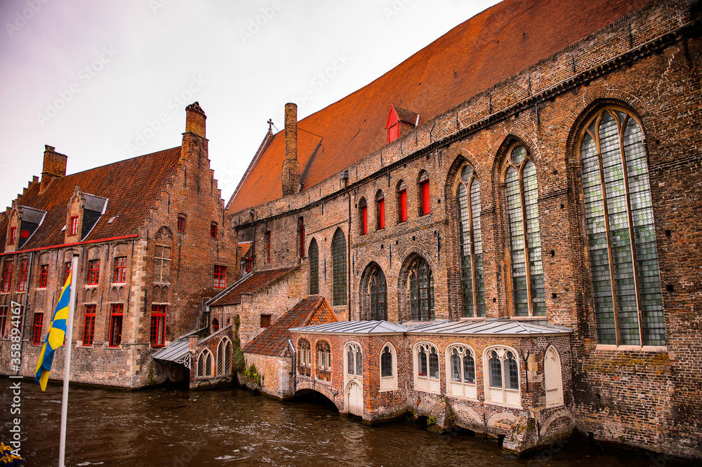 It's Medieval houses with flowers at the windows in the Historic Centre of Bruges, Belgium. part of the UNESCO World Heritage site