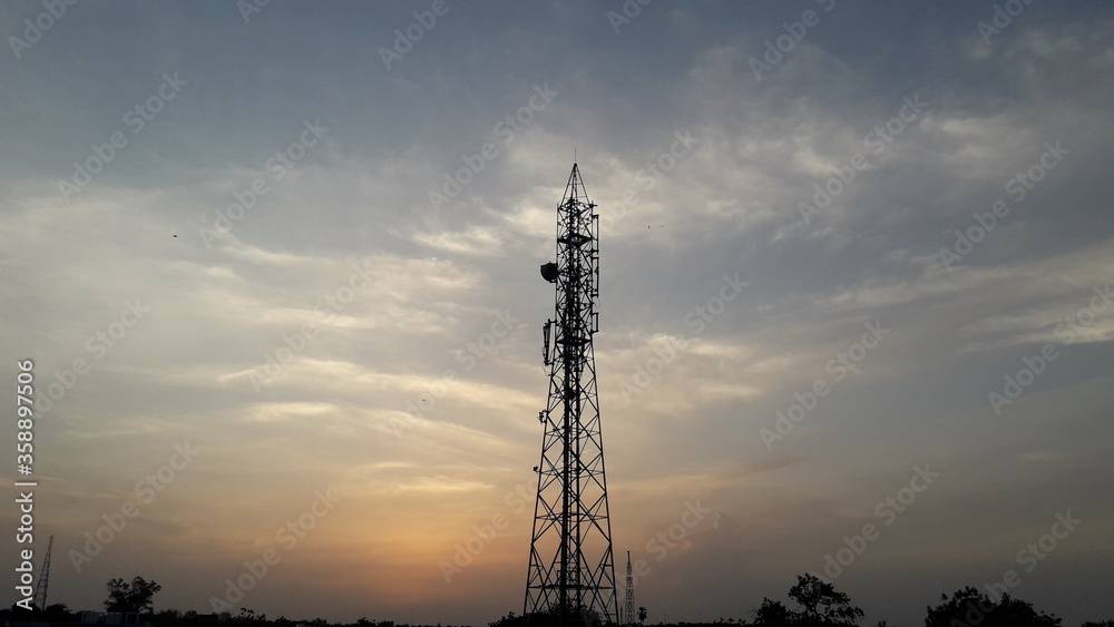 Telecommunication tower in India at the beautiful evening sunset moments with colourful sky background. 