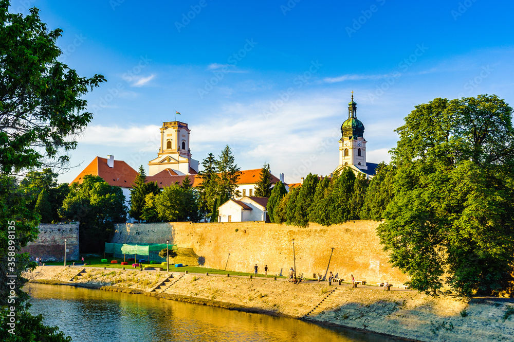 It's Castle of Gyor on the sunset and the Raba river