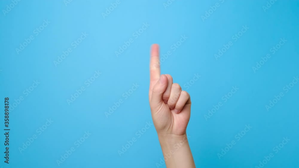 Finger signal. Close up of female hand showing no, isolated on blue studio background with copy space for advertisement. Disapproving gesture. Advertising area, mock up. Finger signal. Close up of female hand showing no, isolated on blue studio background with copy space for advertisement. Disapproving gesture. Advertising area, mock up.