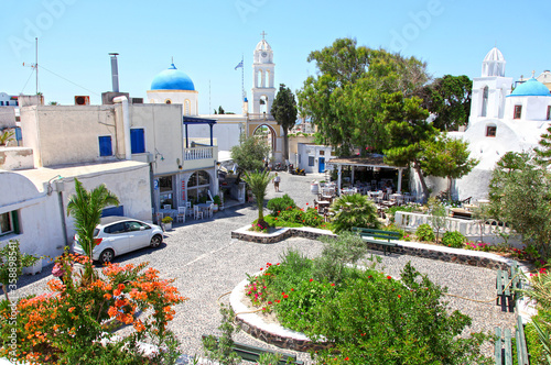 A blue-domed church in the traditional village of Megalochori in Santorini, Greece.