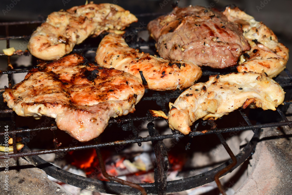Grilled chicken and pork on the grill