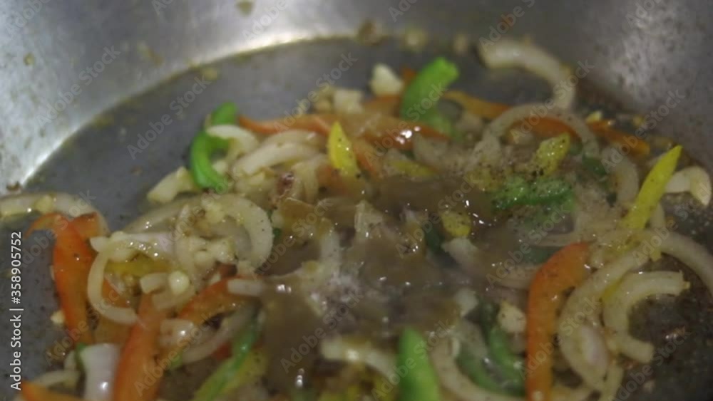 Sautéing vegetables on a pan. Sautéing vegetables on a pan.