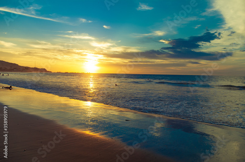 Sunset and a half of a quiet beach. © Nicolas