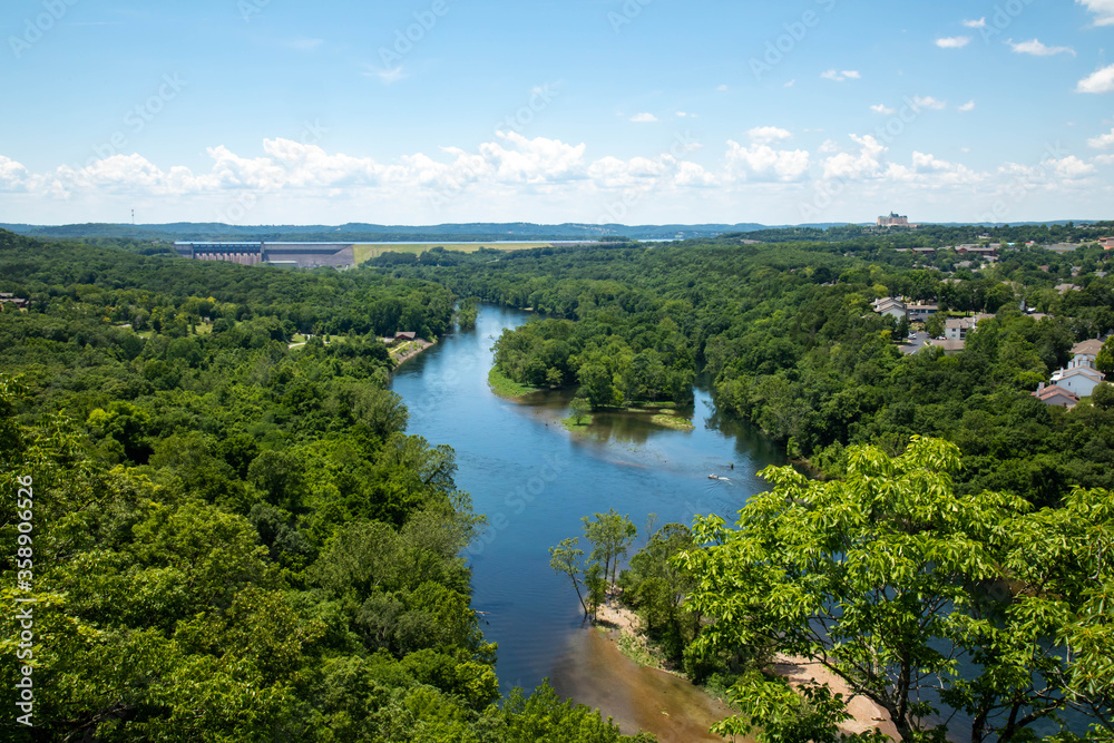 Sweeping landscape vista of Table Rock Lake and surrounding scenery in Branson Missouri on a beautiful sunny blue sky afternoon.