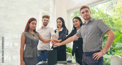Fototapeta Naklejka Na Ścianę i Meble -  Business Partners Trust in Team with hands together to Greeting Start up project Contractor. Businessman Teamwork are Partnership in Office of Team Meeting room. Business Conference Concept