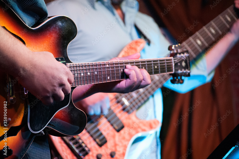 Fototapeta premium man playing electric guitar and bass 