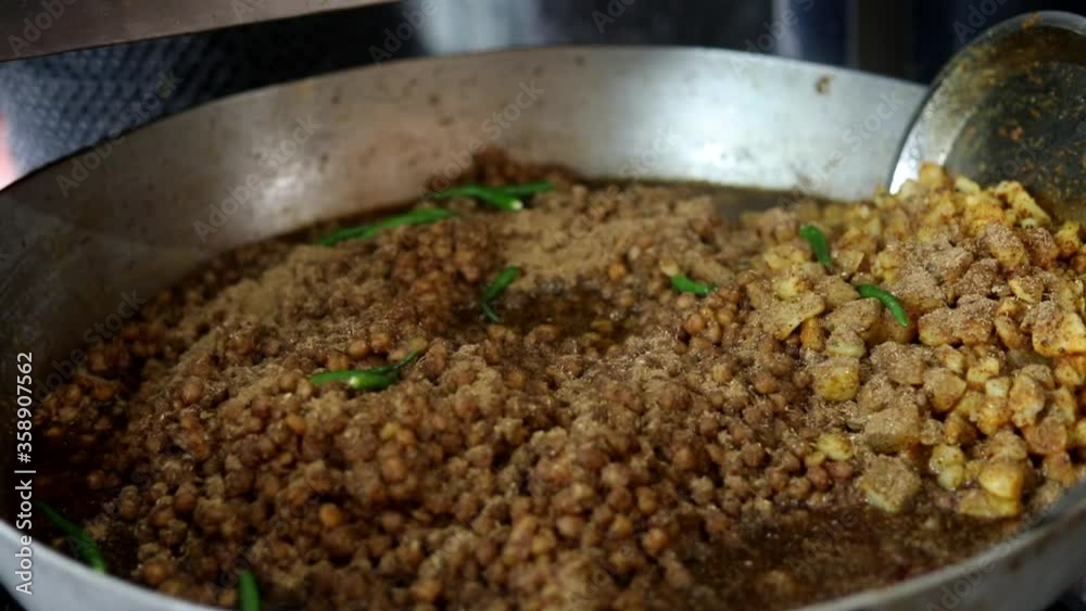 Making choley for cholle bhature serving with onions, red indian salad and peas. Making choley for cholle bhature serving with onions, red indian salad and peas.