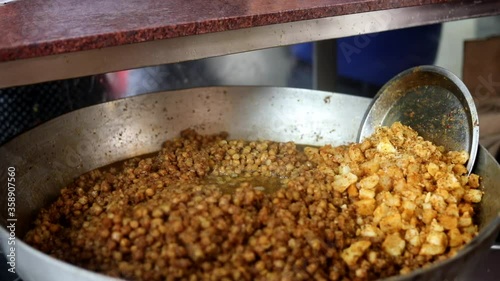 Making choley for cholle bhature serving with onions, red indian salad and peas. photo