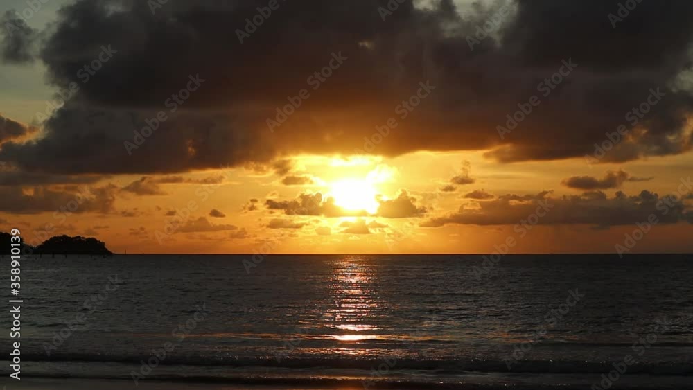Beautiful sunset over the sea with big cumulonimbus at Patong Beach, Phuket, Thailand. Beautiful sunset over the sea with big cumulonimbus at Patong Beach, Phuket, Thailand.
