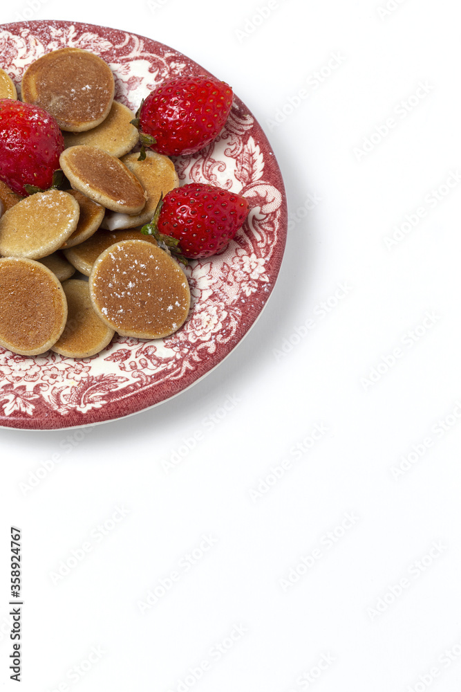 Homemade cereals mini pancake with yogurt, honey and strawberries on colorful background. Homemade cereals mini pancake with yogurt, honey and strawberries on colorful background.