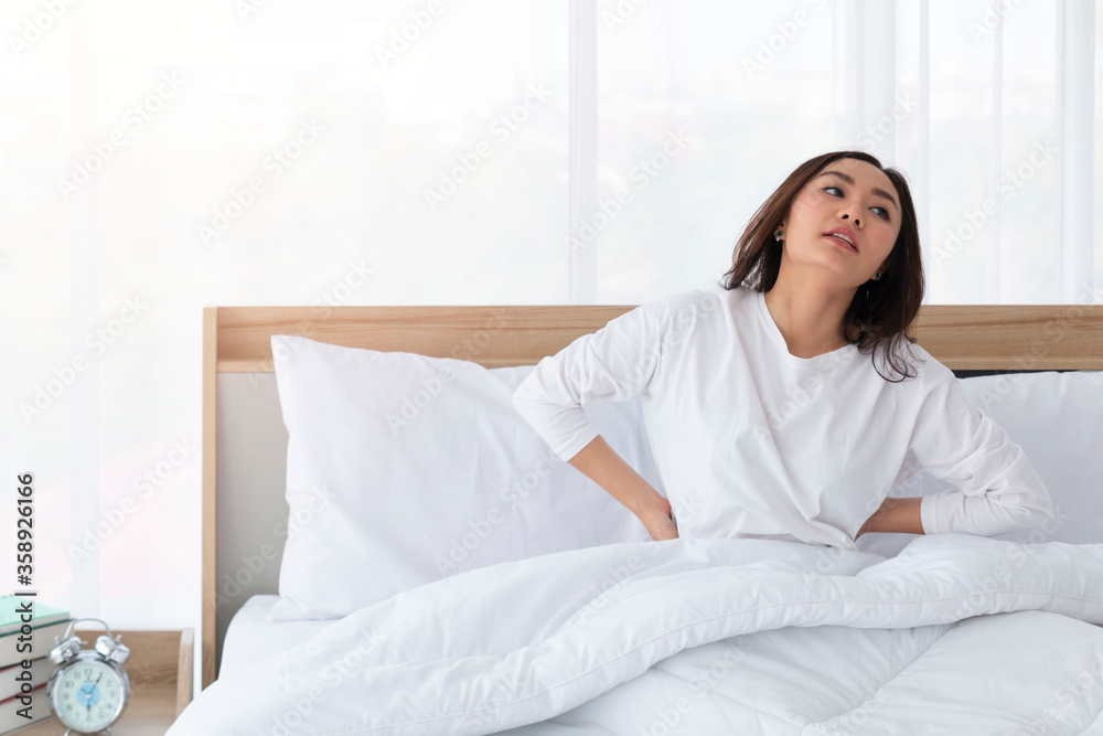 Young girl stretching in bed after wake up. Portrait of beautiful asian woman enjoying fresh soft bed linen mattress in bedroom. Woman Stretching in Her Bed. A Girl waking up in the Morning on bed. Young girl stretching in bed after wake up. Portrait of beautiful asian woman enjoying fresh soft bed linen mattress in bedroom. Woman Stretching in Her Bed. A Girl waking up in the Morning on bed.