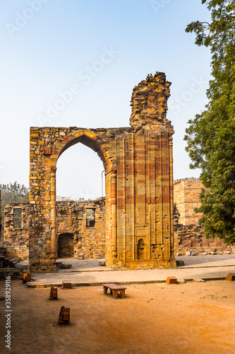 It's Qutb Mosque Arch Ruin at the Qutb complex (Qutub), an array of monuments and buildings at Mehrauli in Delhi, India. UNESCO World Heritage Site photo