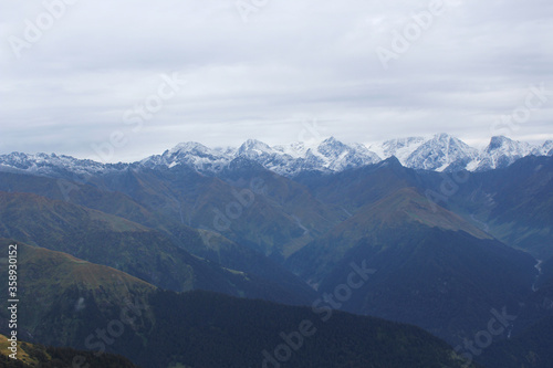 high snow peaked mountains of himalaya with forest all around.