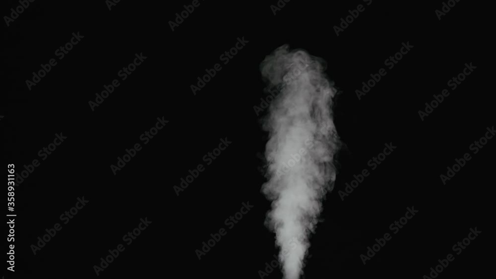 Slow motion thin water mist stream over black background Slow motion thin water mist stream over black background