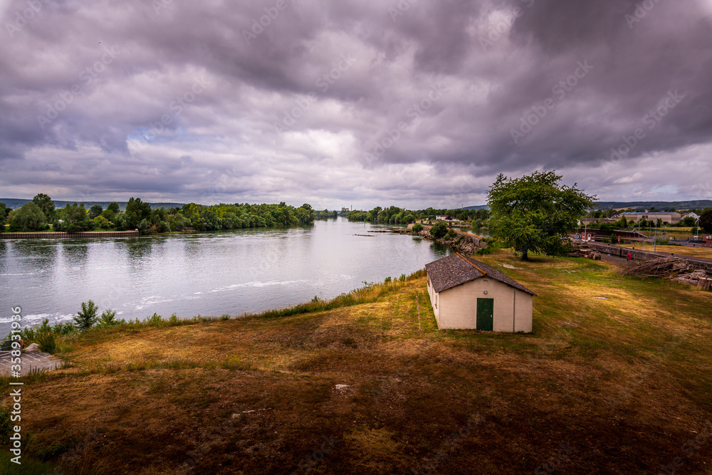 Large view by wide angle on Seine River in France, with public house insulated on side. Solitude feeling