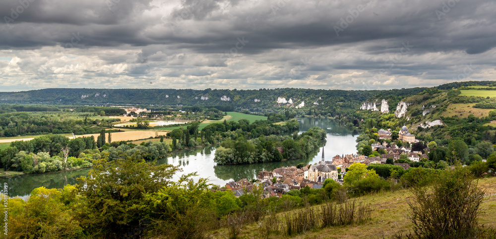 Large view by wide angle on small typical village close to the Seine River near Rouen in France. Nice countryside panorama