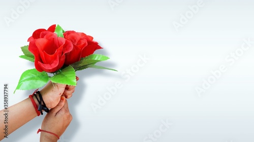 Fototapeta Naklejka Na Ścianę i Meble -  Asian little girl giving roses bouquet isolated in white background with copy space