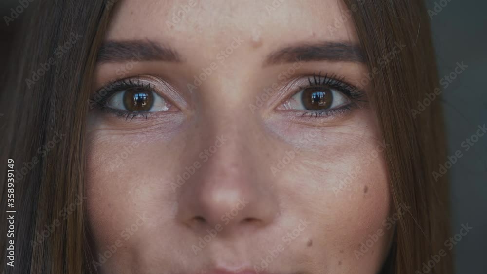 Closeup portrait of beautiful young caucasian female brown eyes looking straight at camera Closeup portrait of beautiful young caucasian female brown eyes looking straight at camera