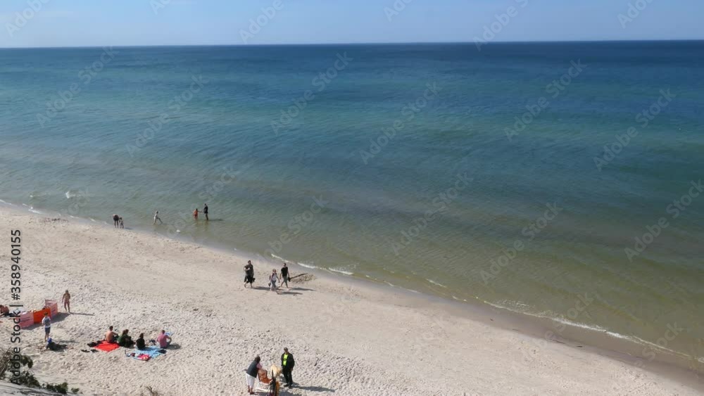 Landscape of Sandy Sea Beach People and Blue and Green Water at Baltic Sea Landscape of Sandy Sea Beach People and Blue and Green Water at Baltic Sea