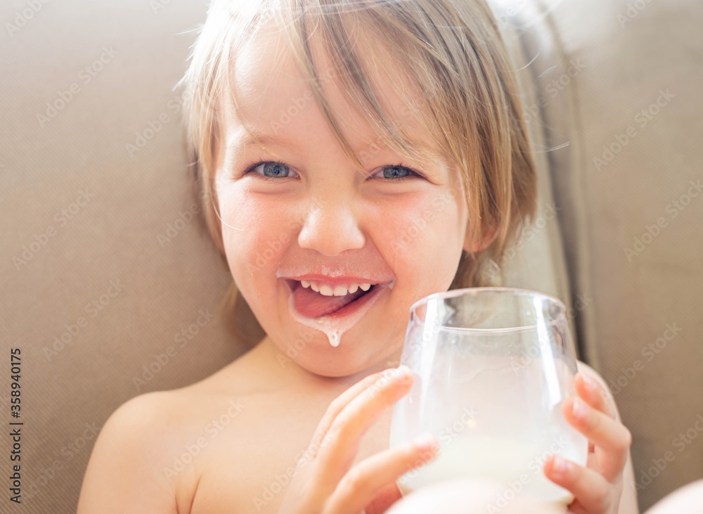 Happy little boy drinking a cup of milk. Dairy and calcium diet. Happy little boy drinking a cup of milk. Dairy and calcium diet.