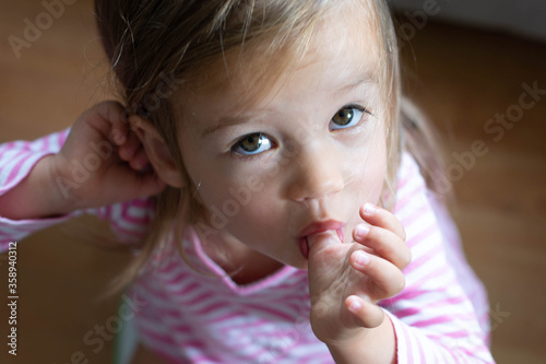 Little toddler sucking her thumb.