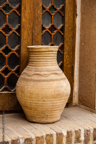 It's Clay jar near the window photo