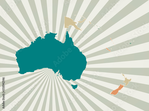 Oceania map. Poster with map of the continent in retro color palette. Shape of Oceania with sunburst rays background. Vector illustration.