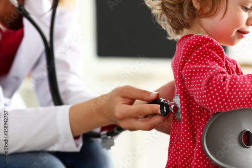 Little child with stethoscope at doctor reception. Physical exam, cute infant portrait, baby aid, healthy lifestyle, ward round, child sickness specialist, clinic test, pulse concept
