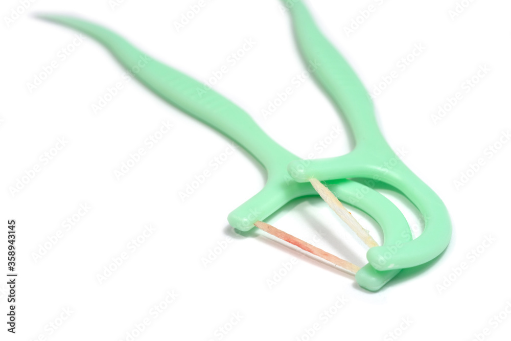 Toothpick and dental floss already used with blood form bleeding gums isolated on white background. Toothpick and dental floss already used with blood form bleeding gums isolated on white background.