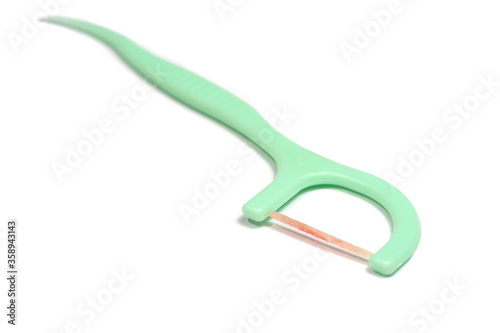 Toothpick and dental floss already used with blood form bleeding gums isolated on white background.