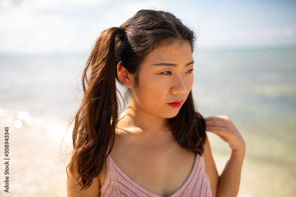 Gorgeous young asian girl posing emotionally with sea waves and horizon on background. Pretty dark-haired girl in sunglasses expressing happiness. Gorgeous young asian girl posing emotionally with sea waves and horizon on background. Pretty dark-haired girl in sunglasses expressing happiness.