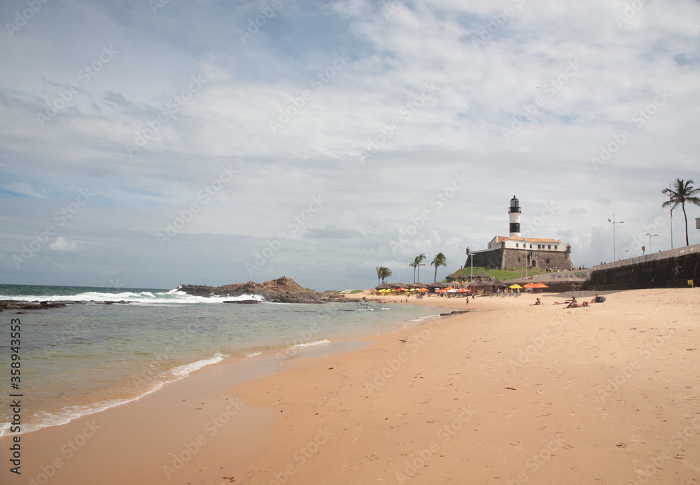 View of Salvador Beach and farol da barra Salvador with palm tree, Bahia, Brazil