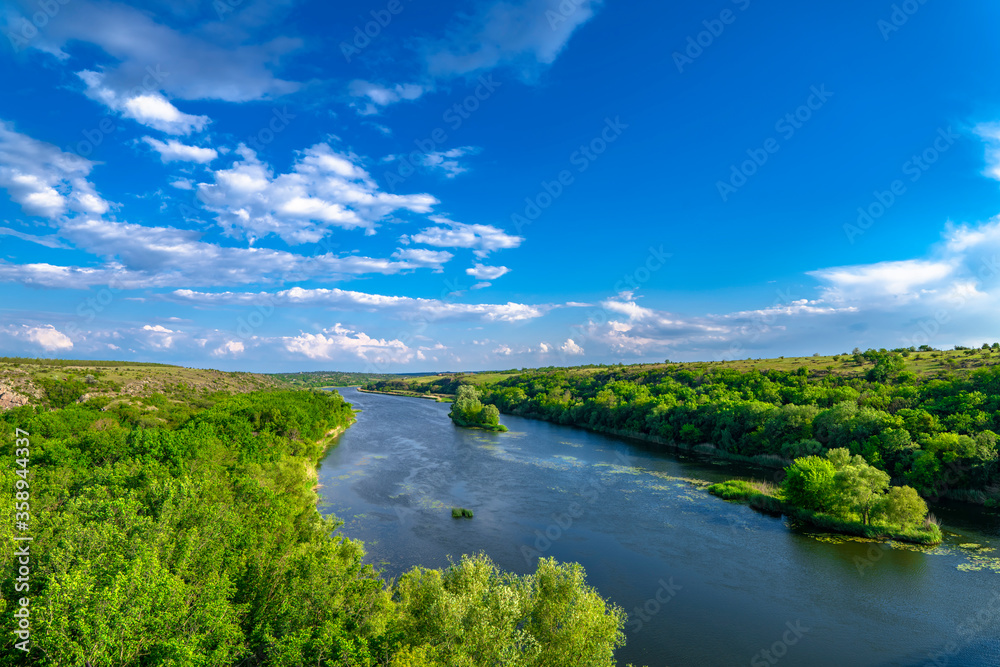 Southern Bug. Yuzhny Buh river flow through green trees. Nature landscape