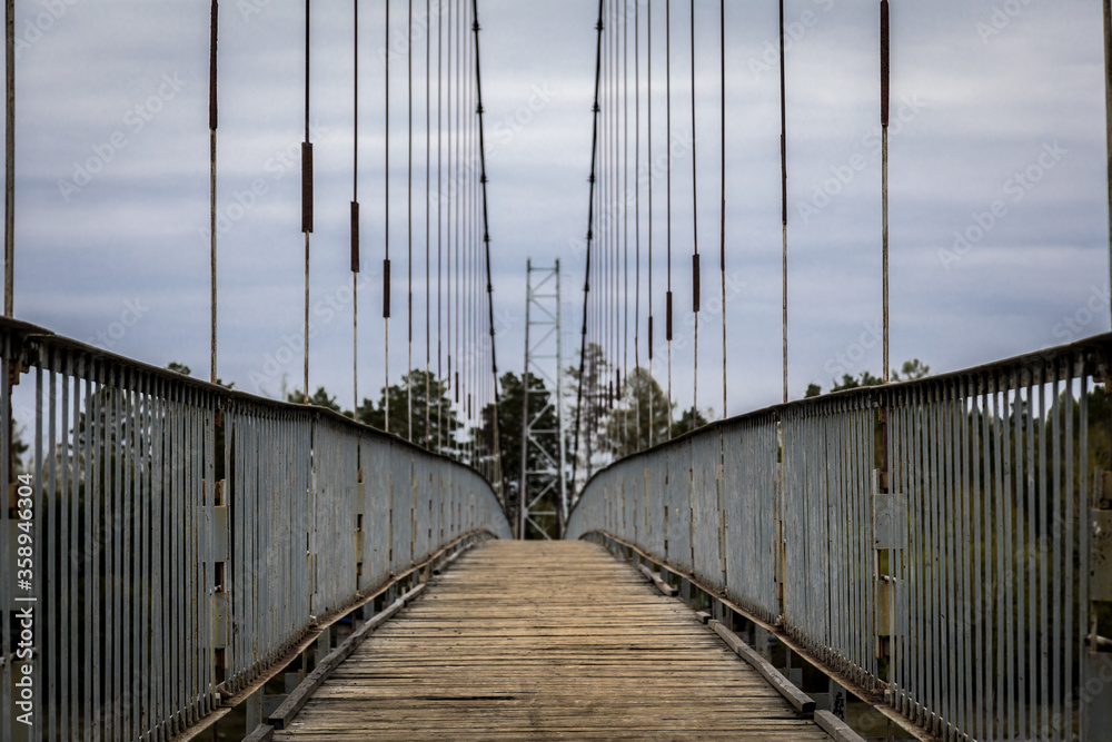 Obraz premium old suspension bridge made of metal and wooden planks