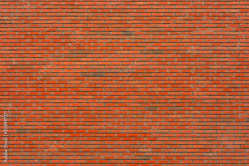 Wall of red brick. Designer interior background. Abstract architectural surface.